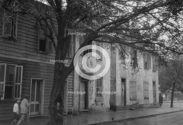Facades of two-story houses, [Alexander Peronneau Tenements, 141 Church Street..., c1920-1926. Creator: Arnold Genthe.