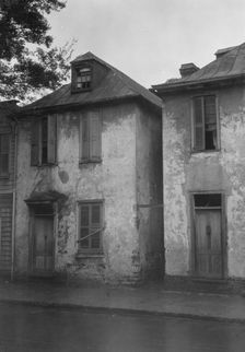 Facades of two-story houses, [Alexander Peronneau Tenements, 141 Church Street..., c1920-1926. Creator: Arnold Genthe