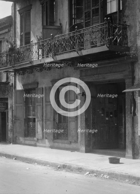Facades of buildings along a street in the French Quarter, New Orleans, between 1920 and 1926. Creator: Arnold Genthe.