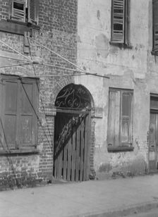 Facades of multi-story buildings, New Orleans or Charleston, South Carolina, between 1920 and 1926. Creator: Arnold Genthe