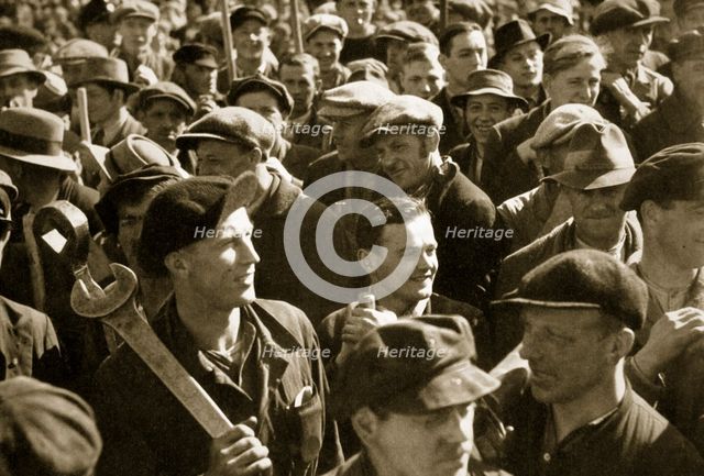 Factory workers with their tools celebrate the traditional Socialist holiday, Germany, 1936. Artist: Unknown