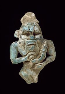 Faience amulet of Bes nursing a Horus, XXVth Dynasty (c770 BC-c715 BC)