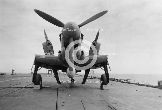 Fairey Firefly aircraft ready to be transported to the hangar lift, HMS 'Venerable', 1945. Artist: Unknown