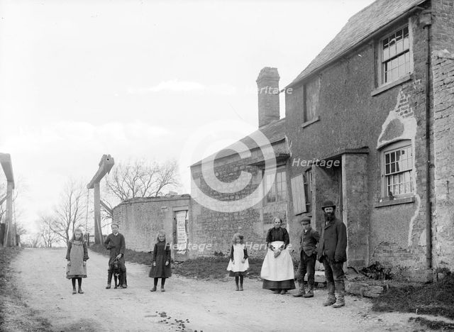 Family outside their cottage with the canal bridge in the background, Uffington, Oxfordshire, 1916. Artist: Henry Taunt