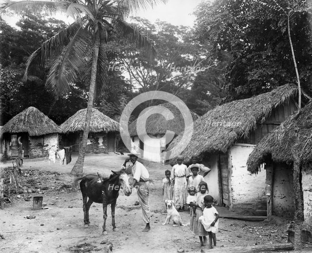 Family outside their home, Coolie Street, Kingston, Jamaica, 1931. Artist: Unknown