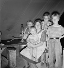 Family of six in tent after supper, FSA mobile unit, Merrill, Klamath County, Oregon, 1939 Creator: Dorothea Lange