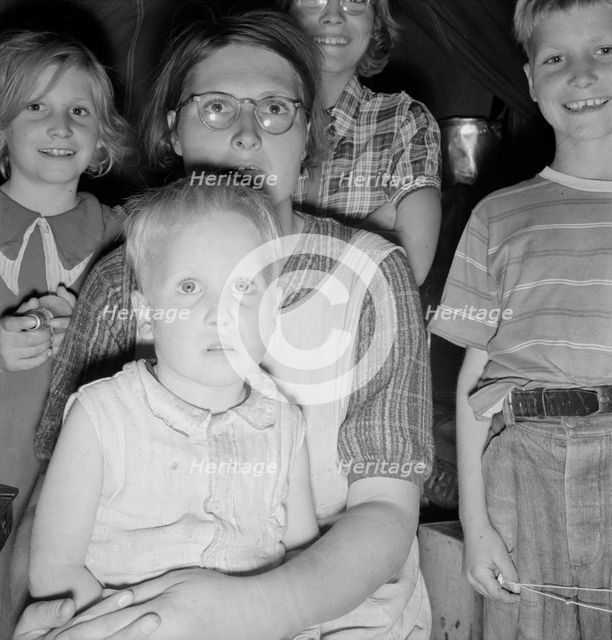 Family of six in tent after supper, FSA mobile unit, Merrill, Klamath County, Oregon, 1939 Creator: Dorothea Lange.