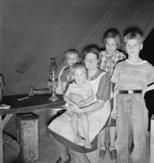 Family of six in tent after supper, FSA mobile unit, Merrill, Klamath County, Oregon, 1939 Creator: Dorothea Lange