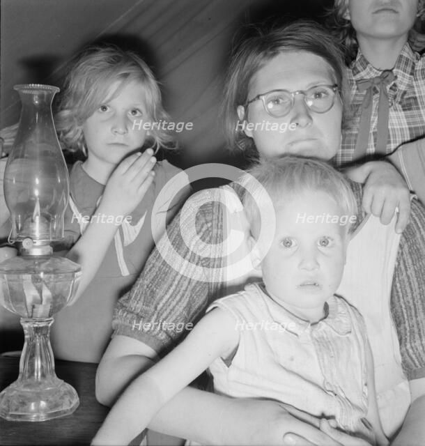 Family of six in tent after supper, FSA mobile unit, Merrill, Klamath County, Oregon, 1939. Creator: Dorothea Lange.
