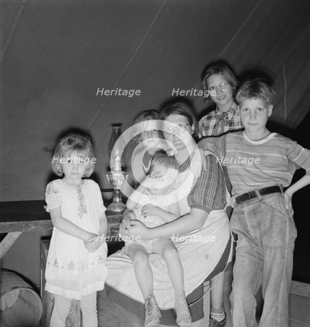 Family of six in tent after supper, FSA mobile unit, Merrill, Klamath County, Oregon, 1939 Creator: Dorothea Lange.