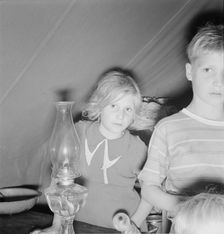 Family of six in tent after supper, FSA mobile unit, Merrill, Klamath County, Oregon, 1939 Creator: Dorothea Lange