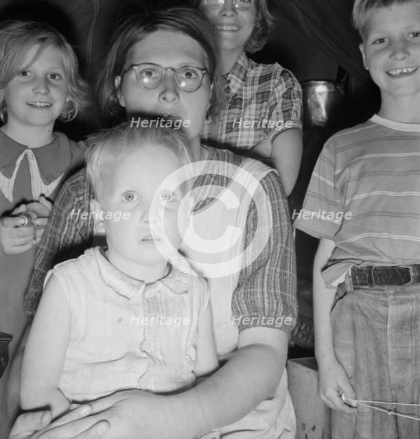 Family of six in tent after supper, FSA mobile unit, Merrill, Klamath County, Oregon, 1939 Creator: Dorothea Lange.