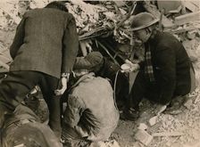 Family buried in a Morrison shelter after a raid, London, 1944