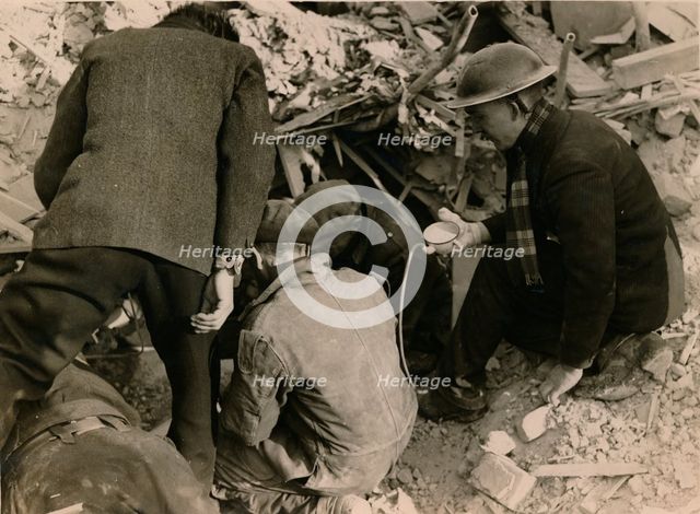 Family buried in a Morrison shelter after a raid, London, 1944. Creator: Unknown.