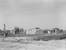 Family from Arkansas with large vegetable garden and small house, Tulare County, California, 1938. Creator: Dorothea Lange