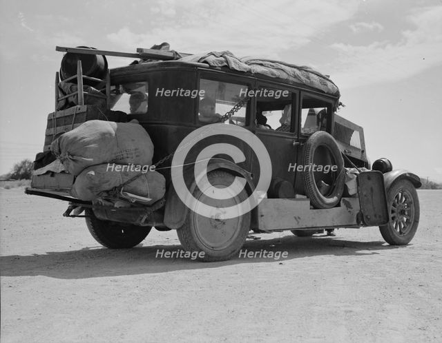 Family...from Fort Smith, Arkansas, trying to repair their car..., Arizona, 1937. Creator: Dorothea Lange.
