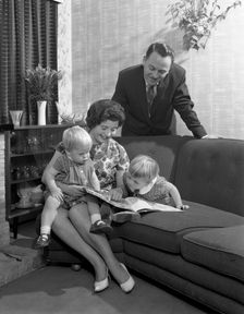 Family group looking at a brochure, Doncaster, South Yorkshire, 1963. Creator: Michael Walters