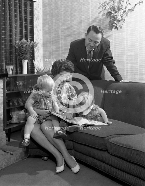 Family group looking at a brochure, Doncaster, South Yorkshire, 1963. Creator: Michael Walters.