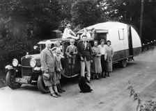 Family group with their 1930 Fiat towing a caravan, (c1930?)