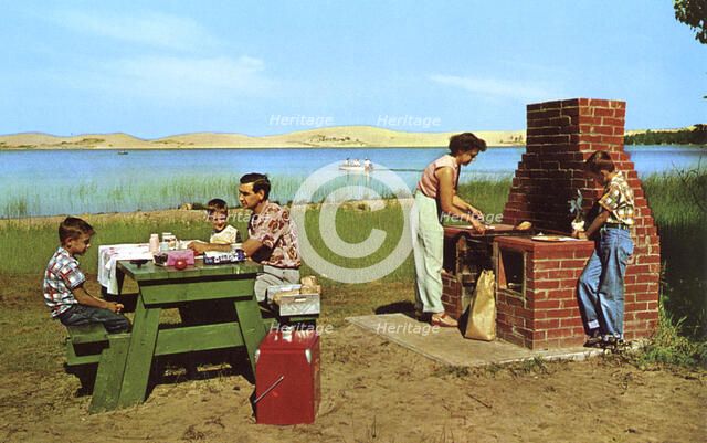 Family having a picnic on the beach by a lake, Michigan, USA, 1955. Artist: Unknown