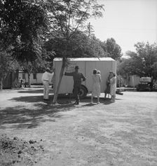 Family inspect a house trailer with idea of purchase, between Tulare and Fresno on U.S. 99, 1939. Creator: Dorothea Lange