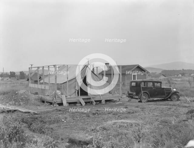 Family living in tent while building the house around them, near Klamath Falls, Oregon, 1939. Creator: Dorothea Lange.