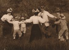 Family playing games in a field 1937
