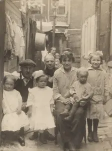 Family portrait in tenement alley, about 1913-1925. Creator: John Frank Keith