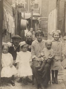 Family portrait in tenement alley, about 1913-1925. Creator: John Frank Keith