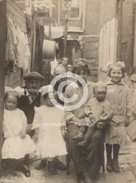 Family portrait in tenement alley, about 1913-1925. Creator: John Frank Keith.