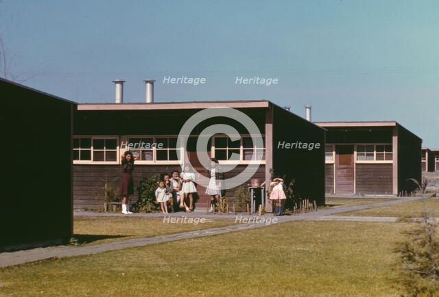 Families of migratory workers in front of their row shelters, FSA ...camp, Robstown, Tex., 1942. Creator: Arthur Rothstein.