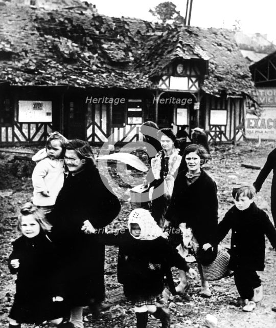 Families leaving their village bombarded during the Normandy landings, France, 1944. Artist: Unknown