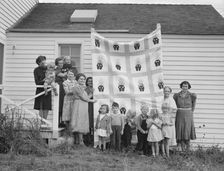 Farm women of the "Helping Hand" club display a pieced quilt..., near West Carlton, Oregon, 1939. Creator: Dorothea Lange