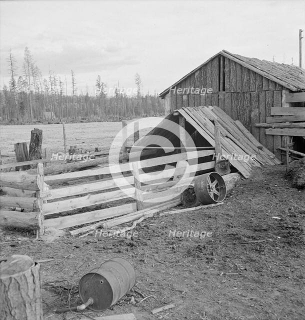 Farm buildings, slab construction, on new stump farm. Boundary County, Idaho, 1939. Creator: Dorothea Lange.