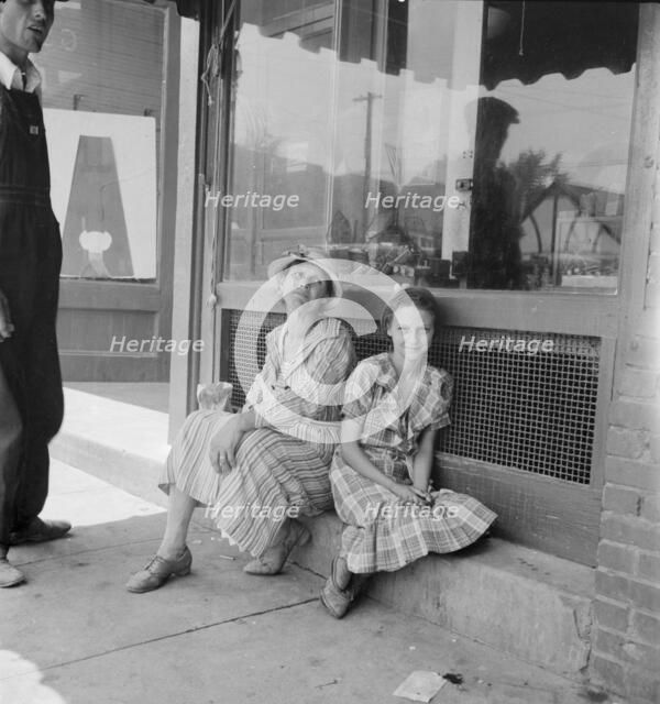 Farm folk spend a day in town, Eden, Alabama, 1936. Creator: Dorothea Lange.
