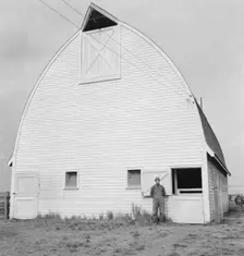 Farmer from Nebraska and his new barn on the Yamhill farms..., Yamhill County, Oregon, 1939. Creator: Dorothea Lange