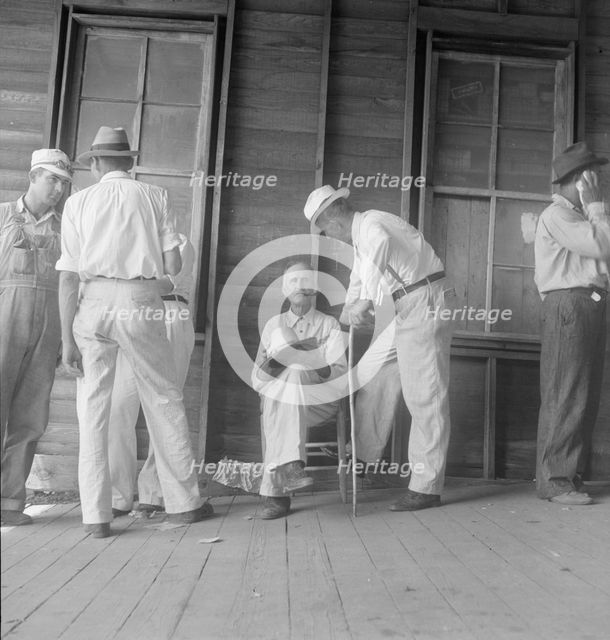 Farmers at tobacco auction, Douglas, Georgia, 1938. Creator: Dorothea Lange.