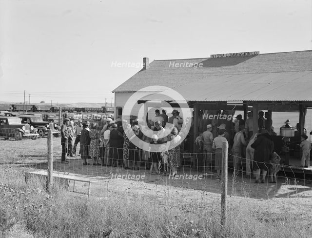 Farmers come to town on Saturday afternoon for auction sale...back street in Nyssa, Oregon, 1939. Creator: Dorothea Lange.