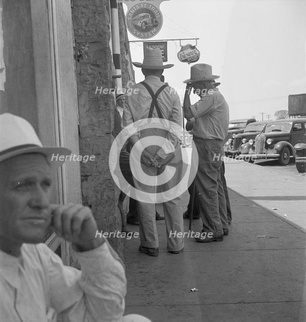 Farmers on main street discussing drought, Sallisaw, Sequoyah County, Oklahoma, 1936. Creator: Dorothea Lange.