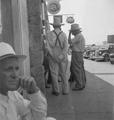 Farmers on main street discussing drought, Sallisaw, Sequoyah County, Oklahoma, 1936. Creator: Dorothea Lange