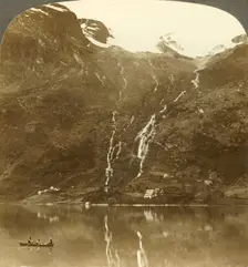 Farmhouses of Yri nestled at the mountain's base - Yri falls on the glacier, Norway c1905. Creator: Unknown
