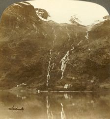 Farmhouses of Yri nestled at the mountain's base - Yri falls on the glacier, Norway c1905. Creator: Unknown