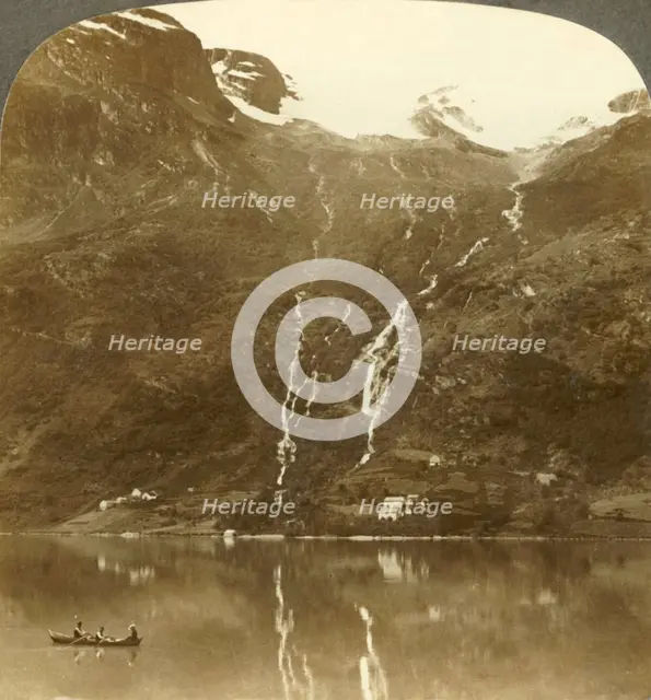 'Farmhouses of Yri nestled at the mountain's base - Yri falls on the glacier, Norway', c1905. Creator: Unknown.