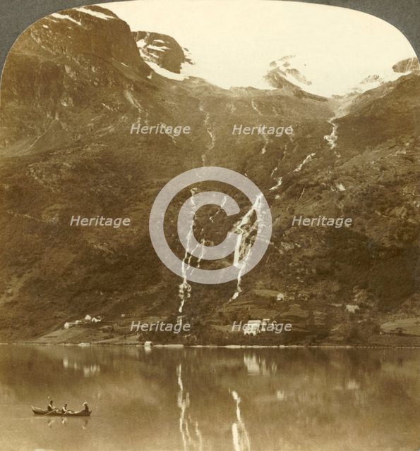 'Farmhouses of Yri nestled at the mountain's base - Yri falls on the glacier, Norway', c1905. Creator: Unknown.