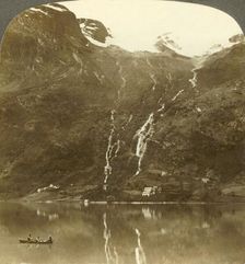 Farmhouses of Yri nestled at the mountain's base - Yri falls on the glacier, Norway c1905. Creator: Unknown