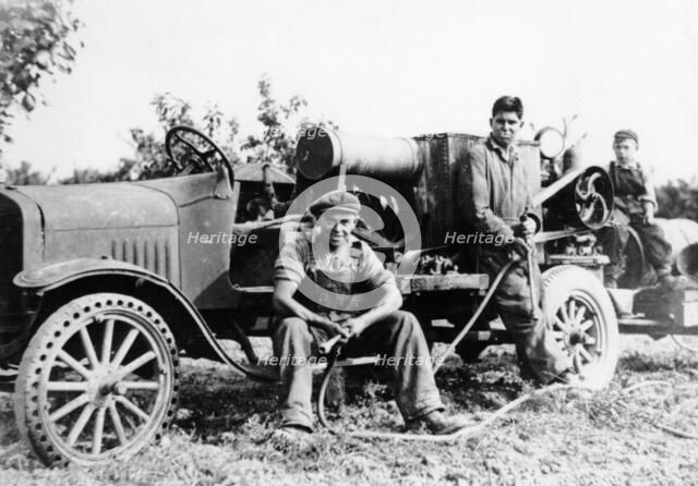 Farmworkers with a tractor, (c1930s?). Artist: Unknown