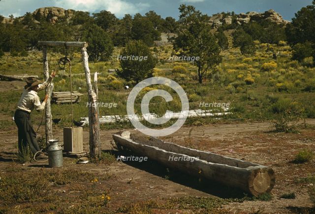 Faro Caudill drawing water from his well, Pie Town, New Mexico, 1940. Creator: Russell Lee.