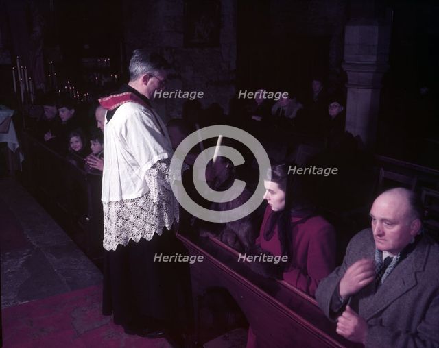 Feast of St Blaise, Benediction of the Throat, ancient custom, London, c1955. Creator: Arthur Charles Kirby Ware.