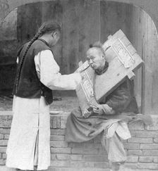 Feeding a prisoner wearing a cangue, China, 1902. Artist: CH Graves