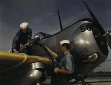 Feeding an SNC advanced training plane its essential supply of gas...Corpus Christi, Texas, 1942. Creator: Howard Hollem